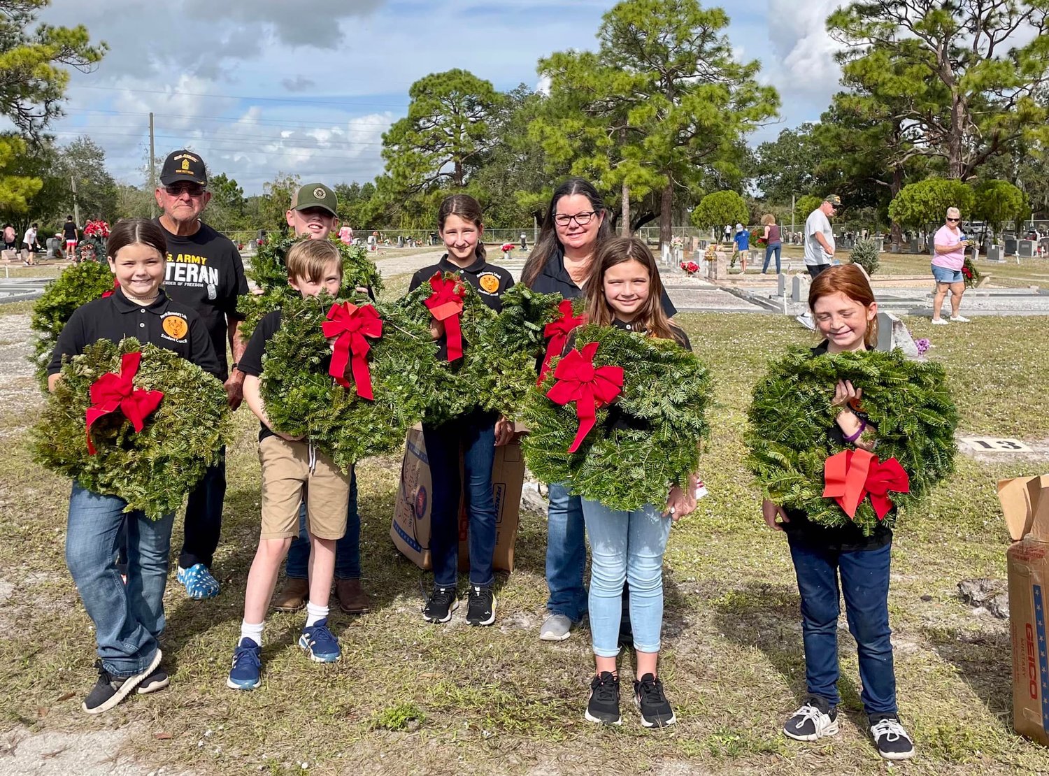 North Elementary School's student council place wreaths on the graves of fallen veterans.